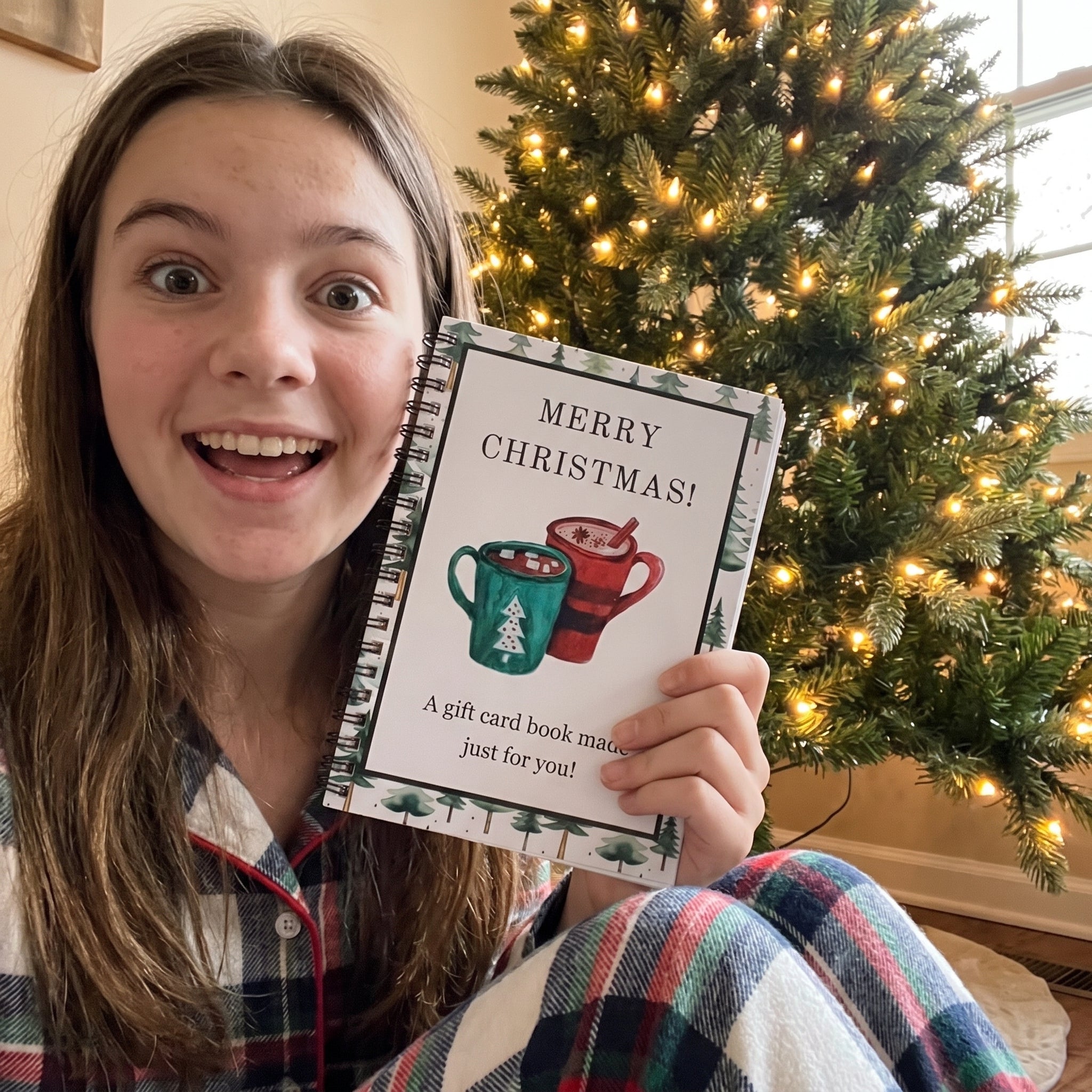 Teen holding the Hot Cocoa gift card book